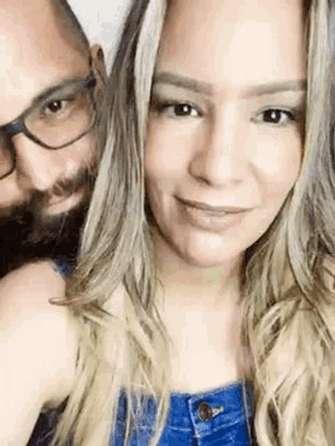 a man and a woman are posing for a picture together .