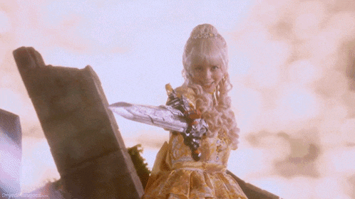 a woman in a yellow dress is holding a sword and smiling