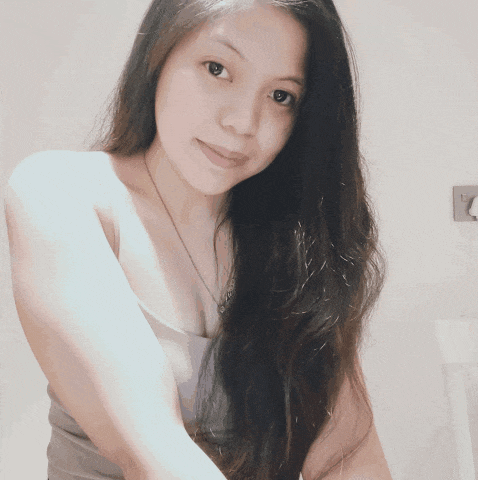 a woman with long hair is wearing a tank top and necklace