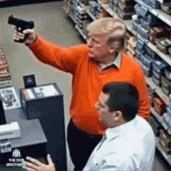 a man in an orange sweater is pointing a gun at another man in a white shirt