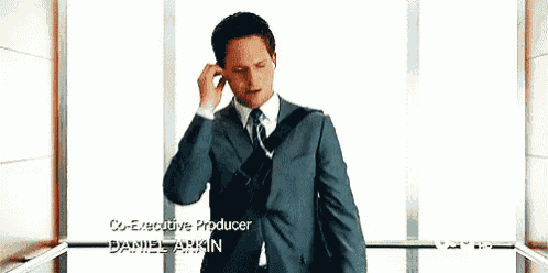 a man in a suit and tie is talking on a cell phone