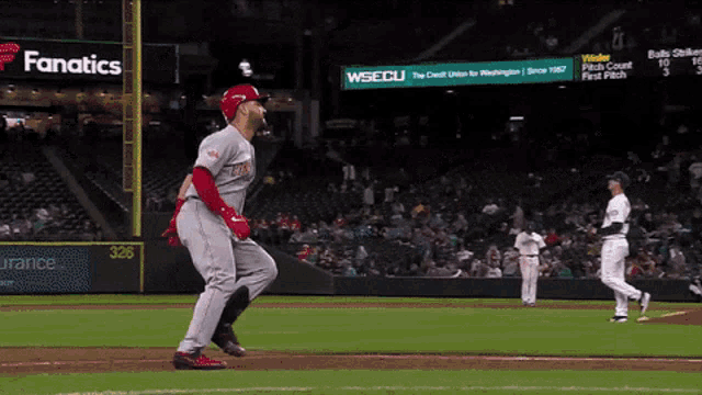a baseball game is being played in front of a sign that says wsecu