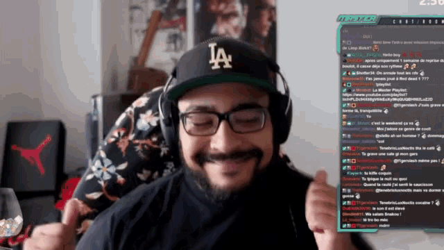 a man wearing a la hat and headphones is smiling