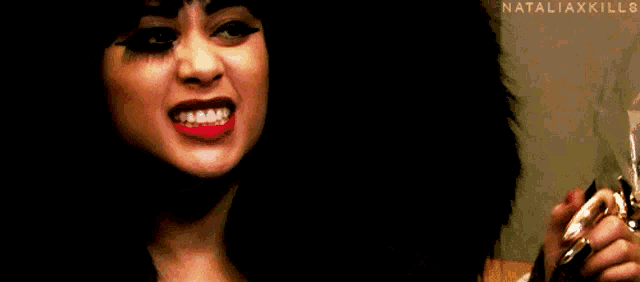 a close up of a woman 's face with nataliaxkills written on the bottom right