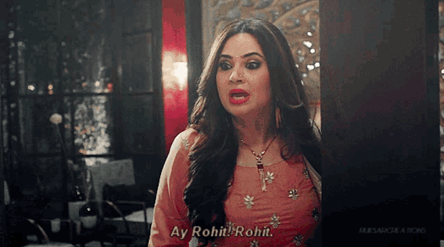 a woman in a pink dress with ay rohit rohit written on her face