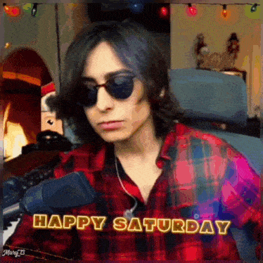 a man wearing sunglasses says happy saturday