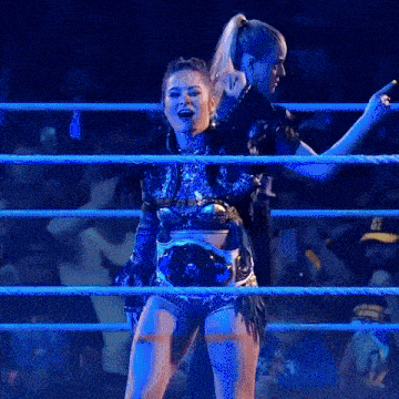 a woman in a wrestling ring wearing a belt that says ' nc ' on it