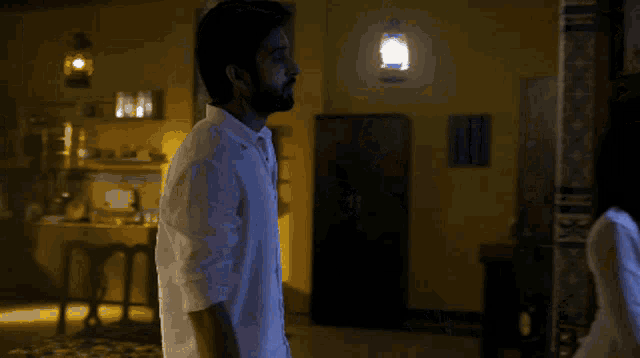 a man and a woman are standing next to each other in a room