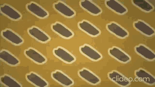 a cartoon hand is reaching out towards a pattern on a wall .