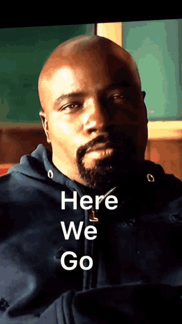 a bald man with a beard and the words here we go on his face
