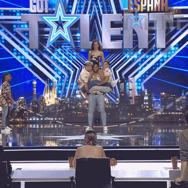 a woman is sitting in front of a talent show