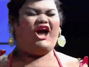 a woman in a red bikini is singing into a microphone .