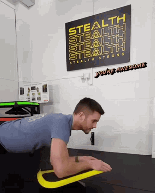 a man is doing push ups in front of a sign that says stealth stealth stealth