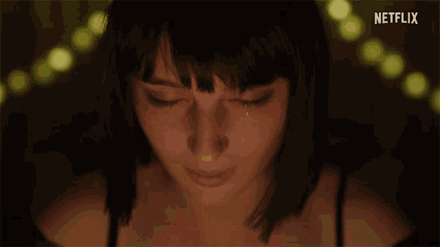a close up of a woman 's face with a netflix logo in the background