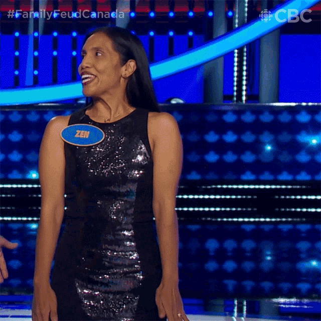 a woman in a black sequined dress with a name tag that says zen