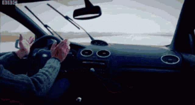 a person driving a car with bbc written on the bottom of the screen