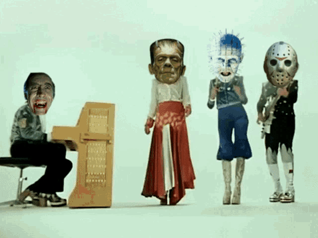 a man playing a piano next to a group of monsters with their faces on their heads