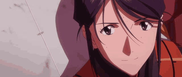 a close up of a woman 's face with a purple hair and a red jacket