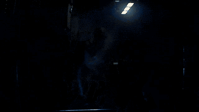 a person holding a stuffed animal in their arms in a dark room