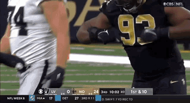 a football player with the number 93 on his jersey is running on the field
