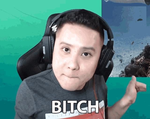 a man wearing headphones and a shirt that says bitch on it