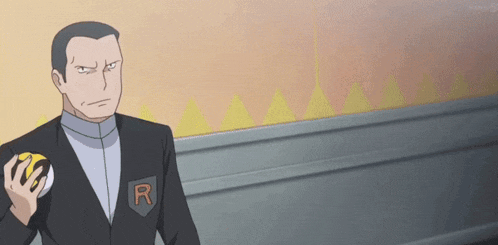 a man in a suit is holding a yellow ball with the letter r on his pocket .