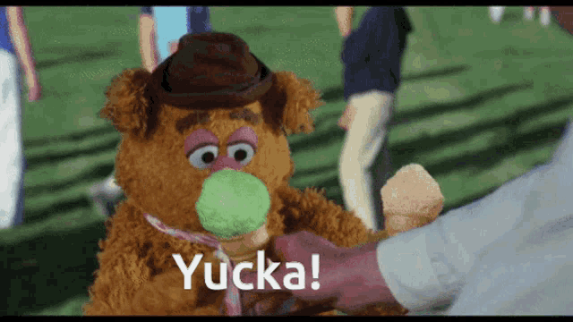 a teddy bear holding an ice cream cone with the word yucca on the bottom