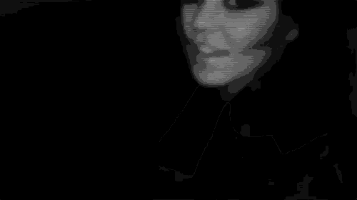 a black and white photo of a woman 's face with a hand covering her face .