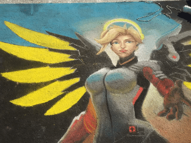 a painting of a woman with yellow wings and a red r on her chest