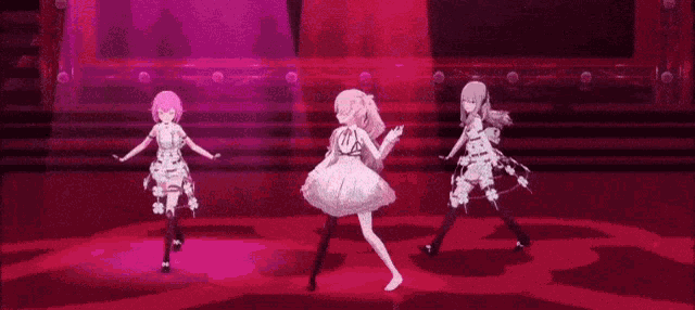 three anime girls are dancing on a stage in front of a red light .