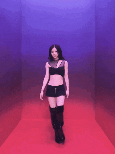 a woman in a black crop top and shorts is dancing
