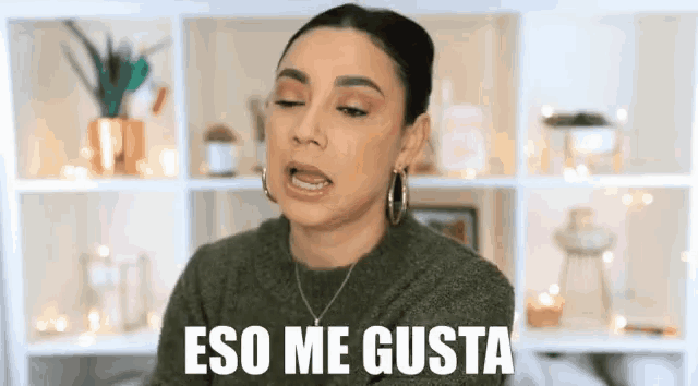 a woman is making a funny face with the words eso me gusta behind her