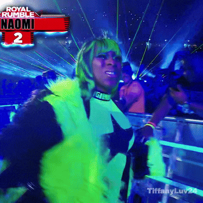 a woman is dancing in front of a sign that says royal rumble naomi