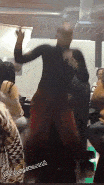 a man in a black shirt is dancing in front of a crowd with the words @urbangemevents on the bottom