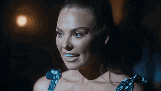 a close up of a woman 's face with her mouth open