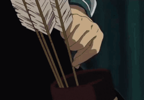 a close up of a person holding an arrow in their hand