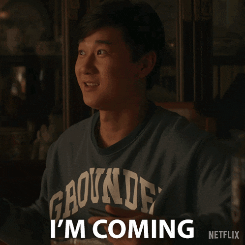 a man wearing a shirt that says gaounde on it says i 'm coming