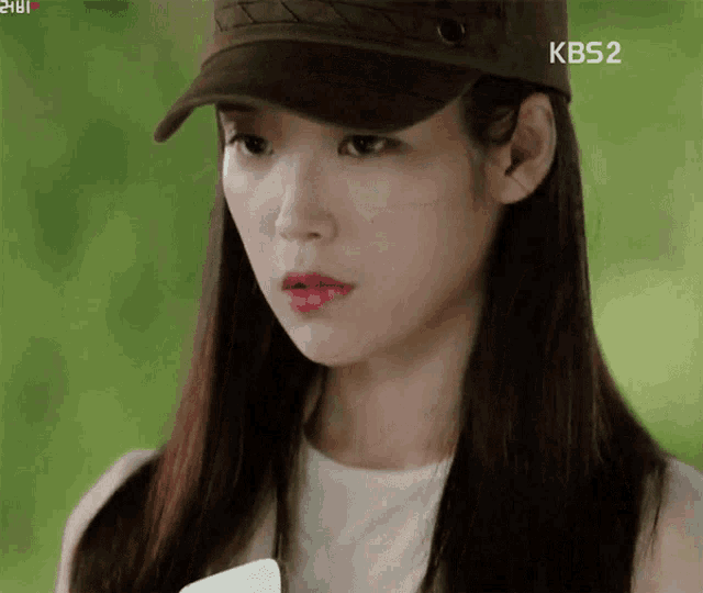 a woman wearing a hat that says kbs2