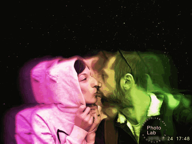 a photo of a man and woman kissing with the time of 24 17:48