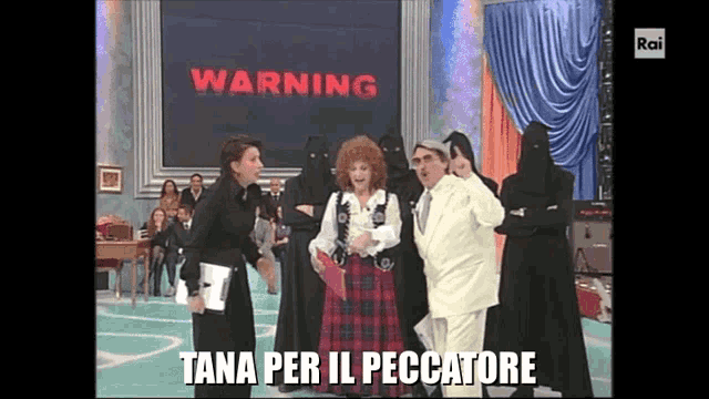 a group of people are standing in front of a warning sign