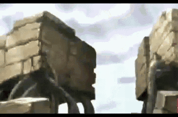 a video game scene with a brick wall and rocks in the background