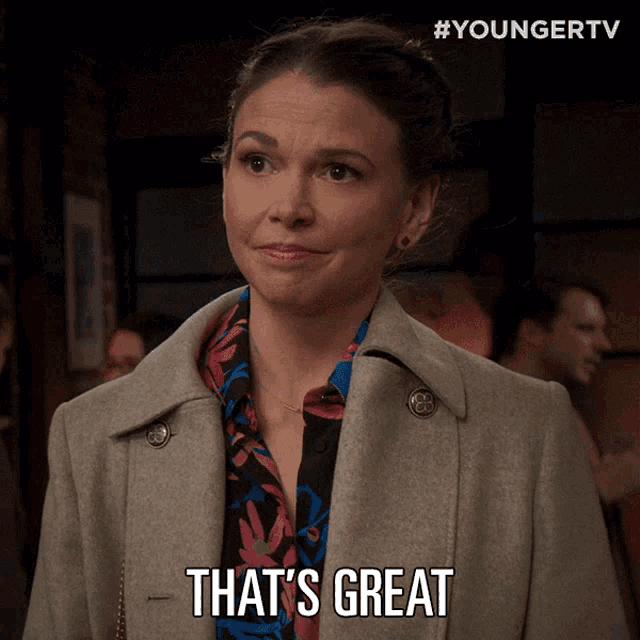 a woman says that 's great while wearing a grey coat