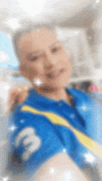 a blurry picture of a man in a blue shirt with the number 3 on the sleeve .