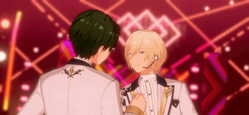 two anime characters standing next to each other on a stage