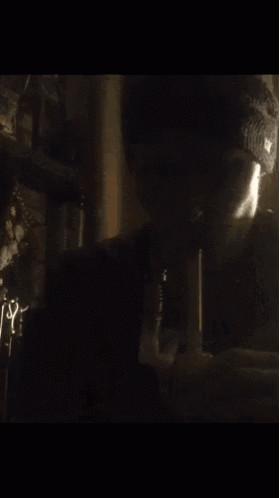 a black and white photo of a person standing in a dark room