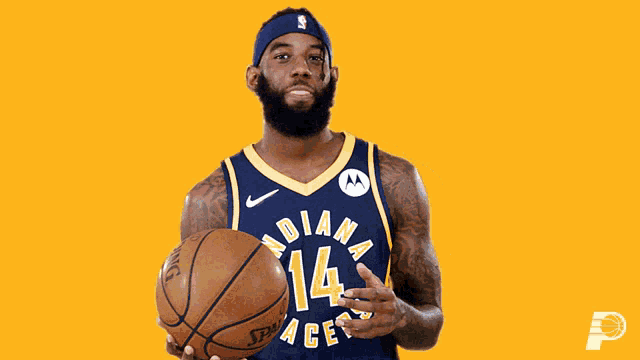 a man in an indiana pacers jersey is holding a basketball