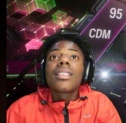 a man wearing headphones and a red jacket with the word cdm on a sign in the background