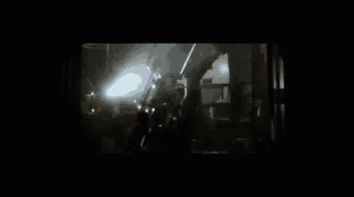 a blurry picture of a dark room with a light coming out of the window
