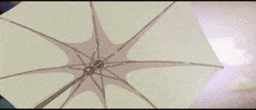 a person is holding an umbrella in front of a tower