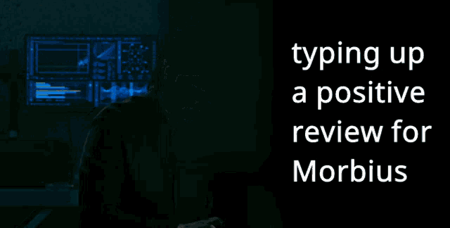 a man is typing up a positive review for morbius on a computer